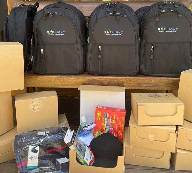 One Light Charity backpacks with Christmas gift boxes