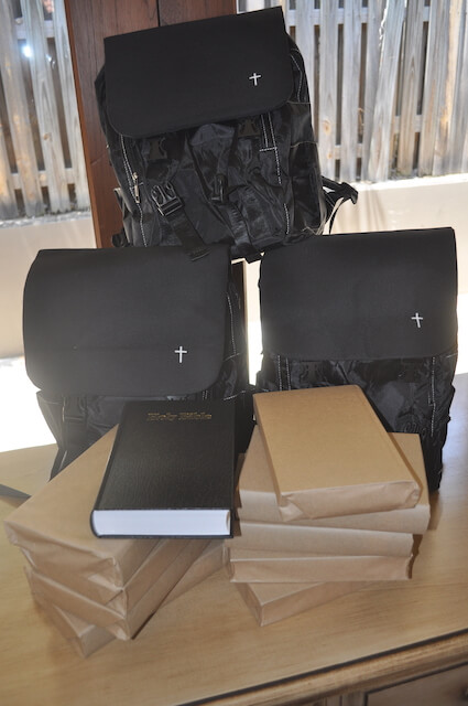Image of black backpacks with Bibles