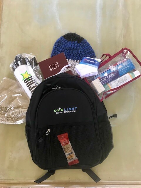 One Light Charity backpack with items