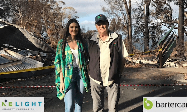 Young woman and older man standing at the Binna Burra site after it was destroyed by the bushfires