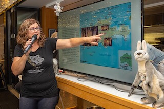 Women pointing to a map on a big screen