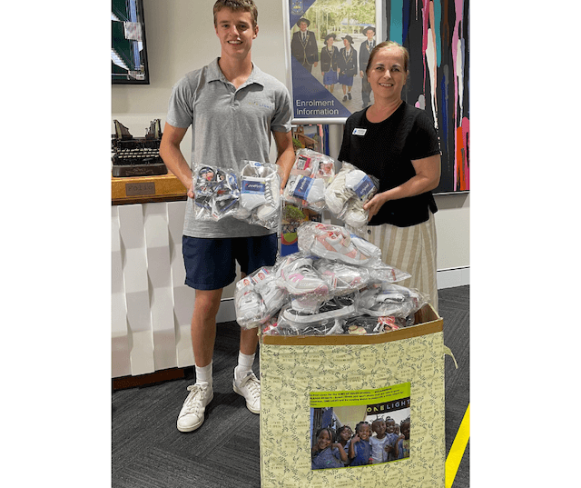One Light Charity volunteer donates school shoes to Mozambique King of Kings School