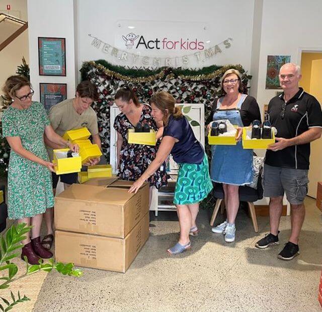 Donating school shoes in yellow boxes