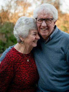 Elderly couple hugging and laughing