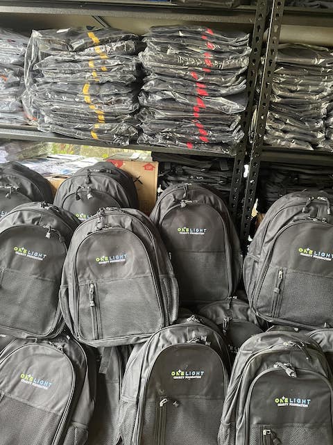 Heap of One Light Charity Backpacks and shirts