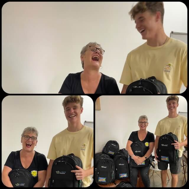 One Light Charity volunteer laughs and has fun while delivering backpacks